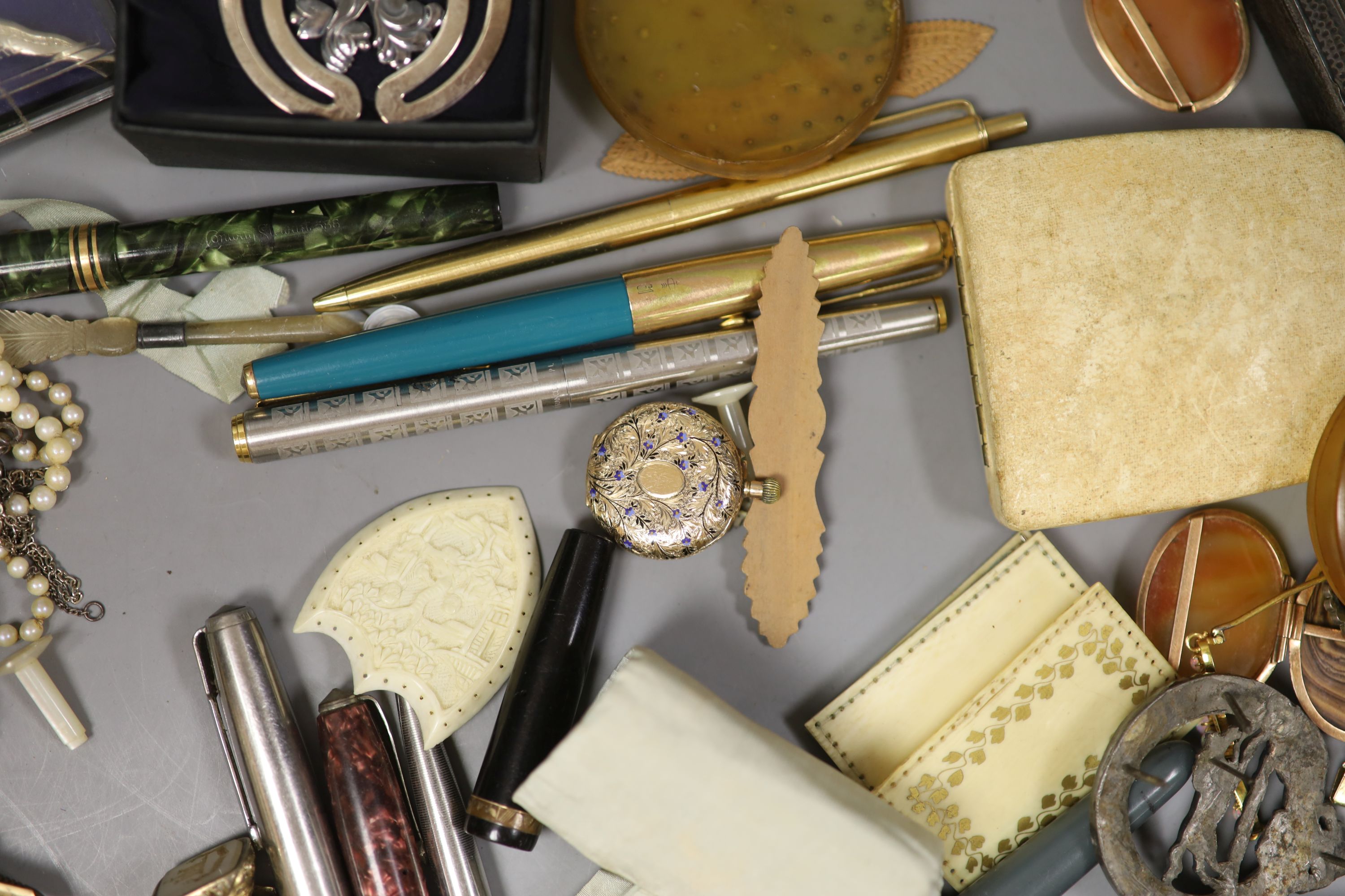 A mixed quantity of jewellery and collectables including 14lk fob watch, a cased set of three yellow metal dress studs, a 9ct opal and seed pearl brooch, a 9ct ring, Georg Jensen clip, costume jewellery, pens etc